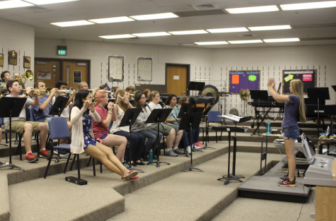 Senior SaraJane McDonald leads the marching band in rehearsal. Photo by McKelvey Collins