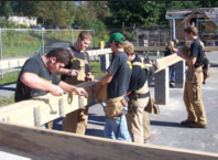 Building trades students work on a project outside