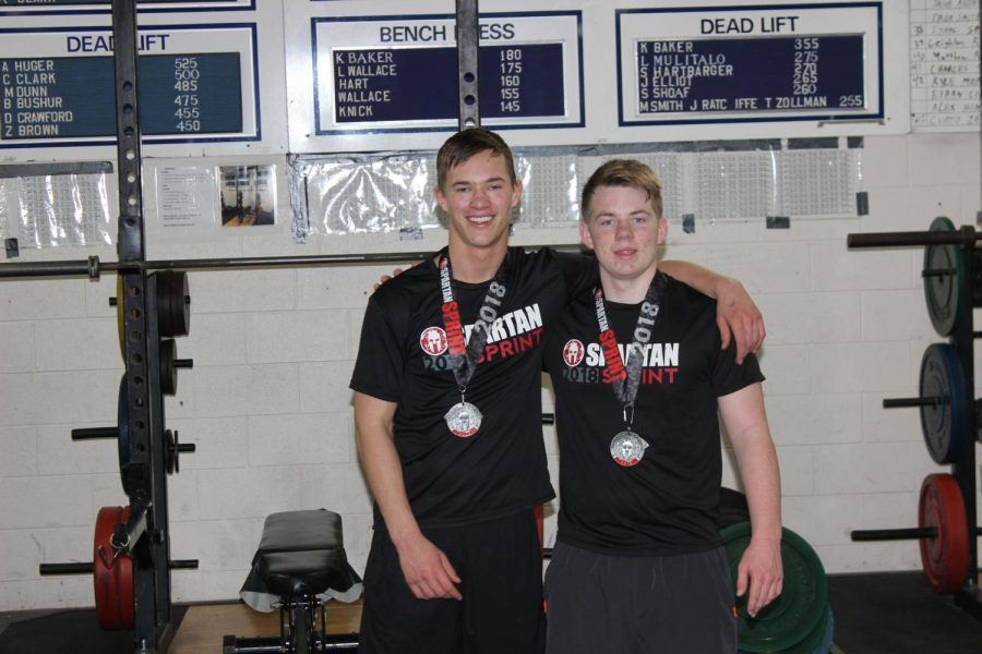 John Ryan Sedovy (left) and Dylan Covington (right) stand with their Spartan Race Medals