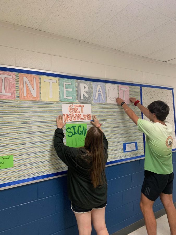 Co-presidents+Margaret+and+Adam+prepare+posters+for+the+Interact+Board.