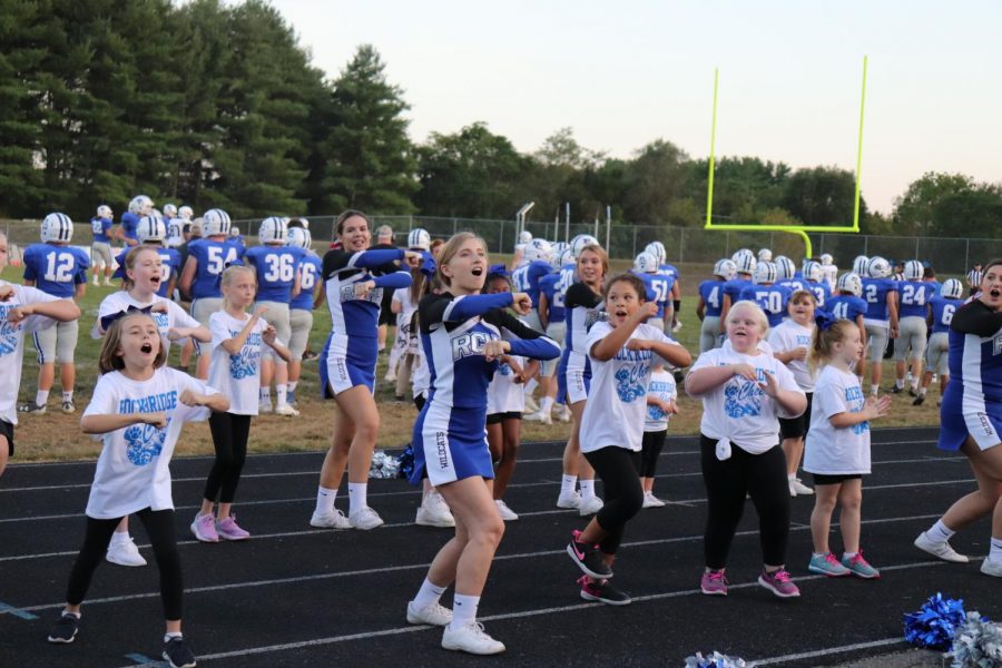 The little cats are cheering alongside RCHS varsity cheerleaders.