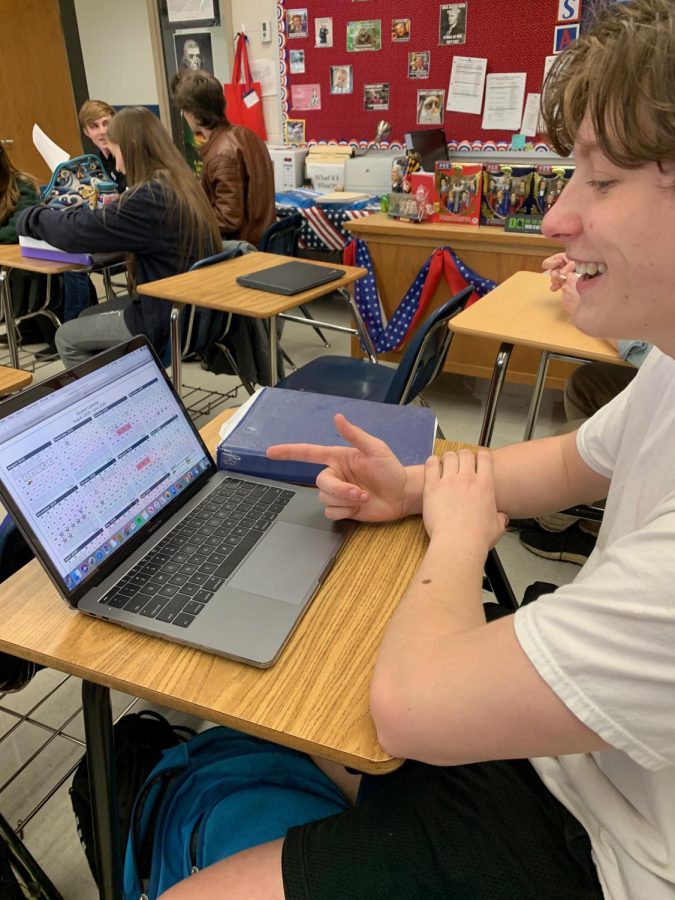 Junior Joseph Sailor looks at the final draft for the 2019-2020 calendar. 