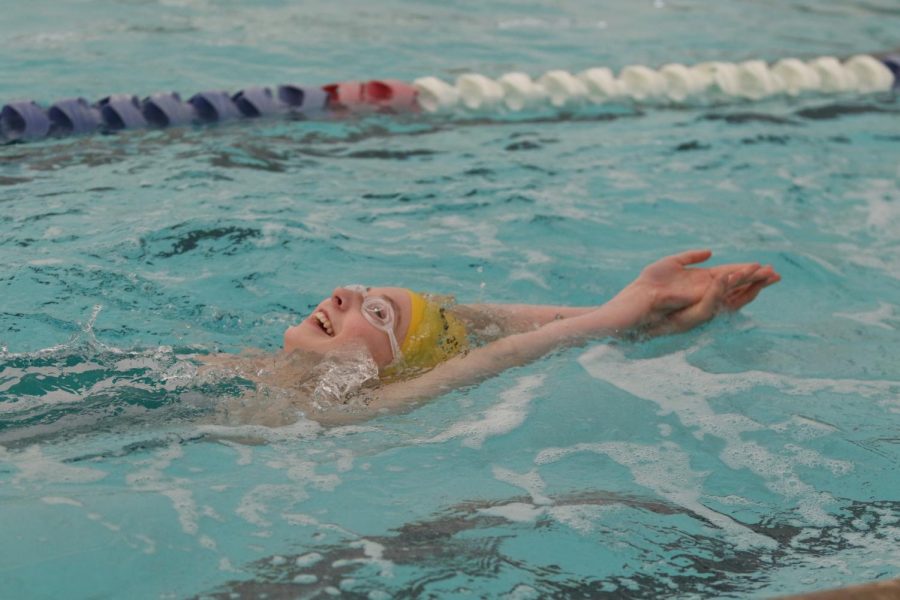 Freshman Ali Pfaff practices her backstroke for the next meet.