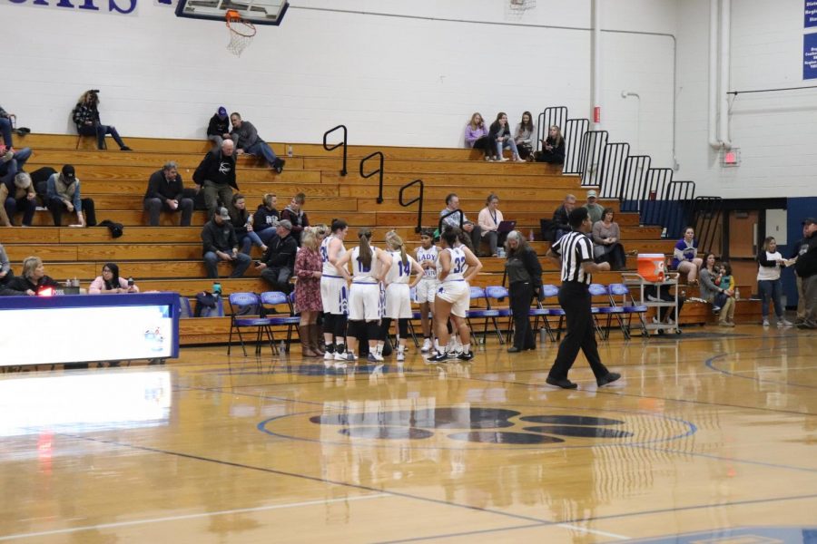 Girls team huddling in a timeout. 