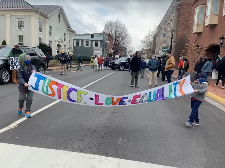 Lexington residents hold a banner at the Stand Up