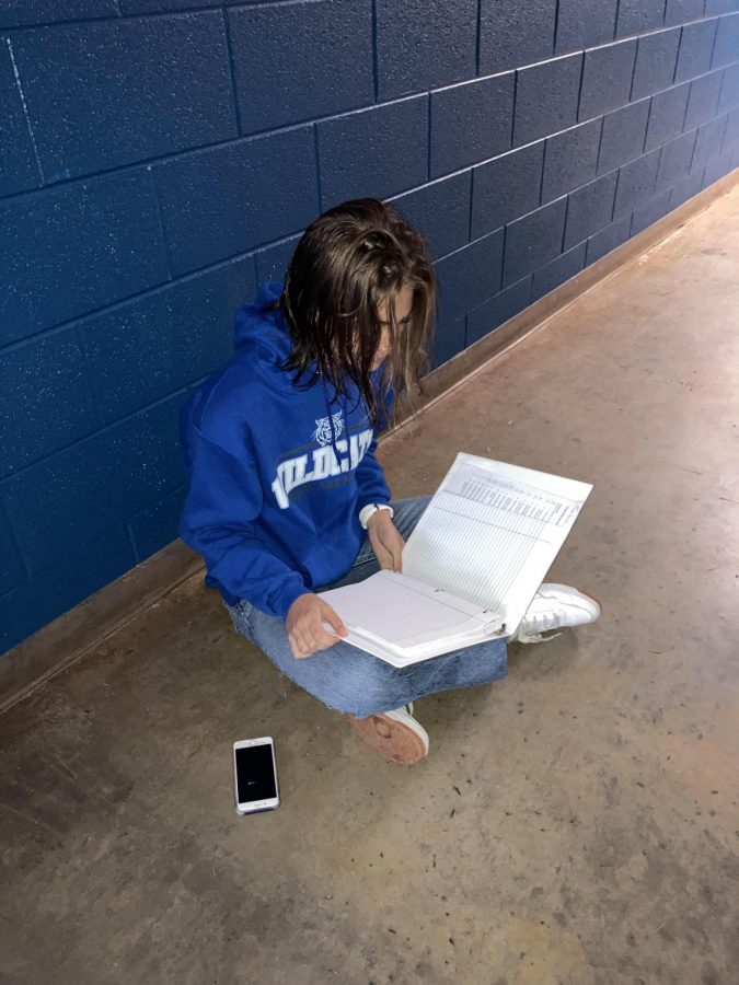 Cross Country runner Megan Timmes does homework after an early morning practice.