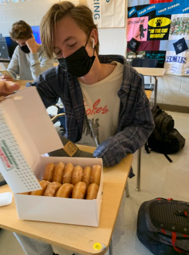 Rockbridge County student, Adam Elrod opens his box of donuts.
