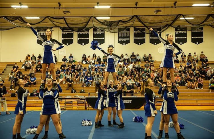 The Competition Cheerleading team competing at districts.
PC: @_cat_pack_