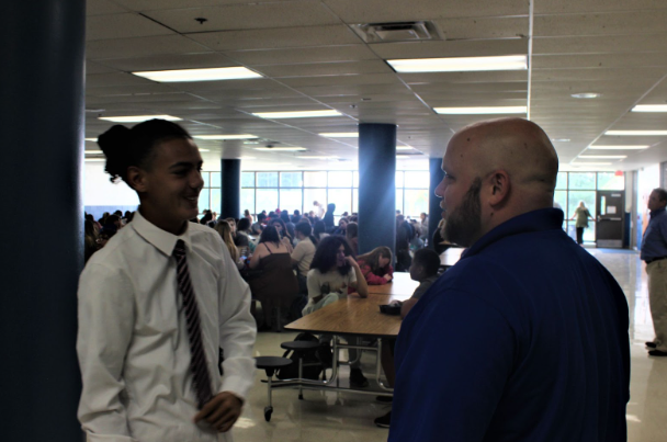 Assistant Principal Dan Fallen talks with a student.
