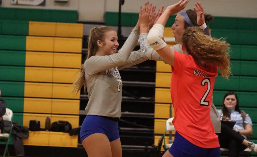 Mckenzie Burch celebrates with her teammates after scoring during a set against Northside