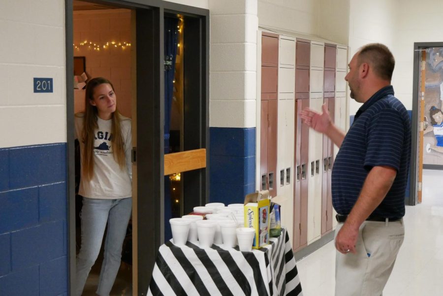 Mr. Andy Coffey informs Ms. Rebekah Butler of her choices for the coffee cart.