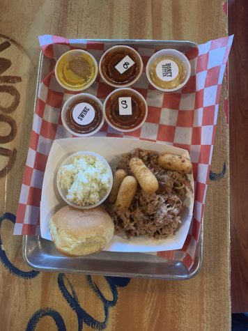 JJ's Meat Shack BBQ Platter with hushpuppies, roll, and sauces.