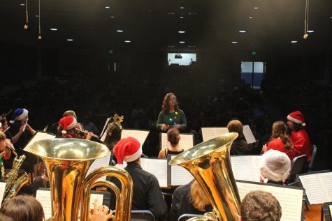 Band director Miranda Fitzgerald directing the symphonic band during a song. 