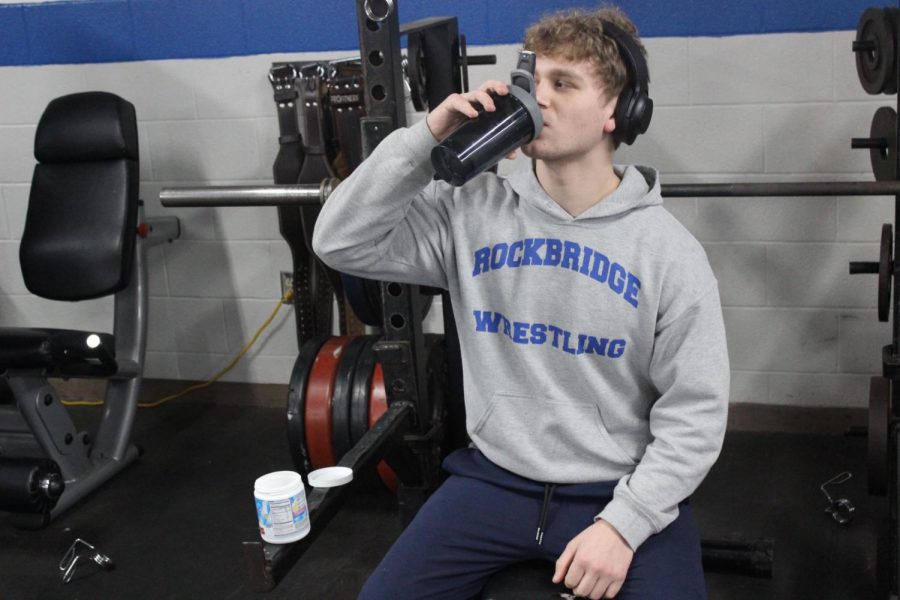 Senior River Hull drinking pre-workout before his strength training class 