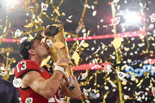 Stetson Bennett celebrates after his MVP performance against TCU.
“Georgia quarterback Stetson Bennett celebrates with the national championship trophy after the Bulldogs’ win over TCU in the College Football Playoff national championship Monday at SoFi Stadium” by Wally Skalij, from the LA Times.