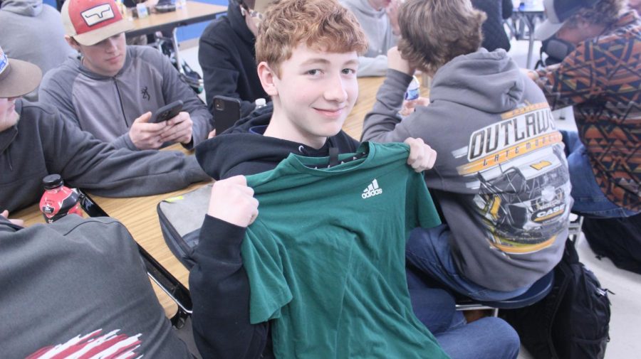 Aidan Rogers holds up a green shirt in celebration of St. Patricks Day. 
