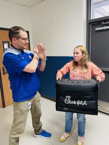 A posed picture of Mr. Fleshman stopping a food delivery. 
Photo credit: Baileigh Ramsey 
