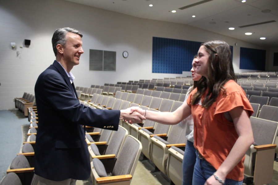 Seniors Caroline and Caitlyn Haynes shake hands with Representative Cline. 