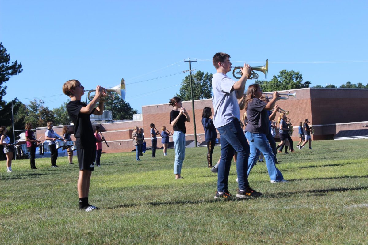 Marching band members practicing in their new field