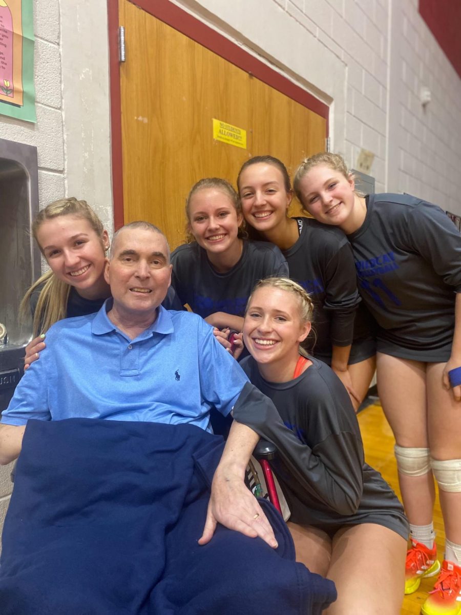 Burch smiles with his daughter, and her four fellow volleyball seniors before a big regular season game. Photo courtesy of Jaden Harrison. 