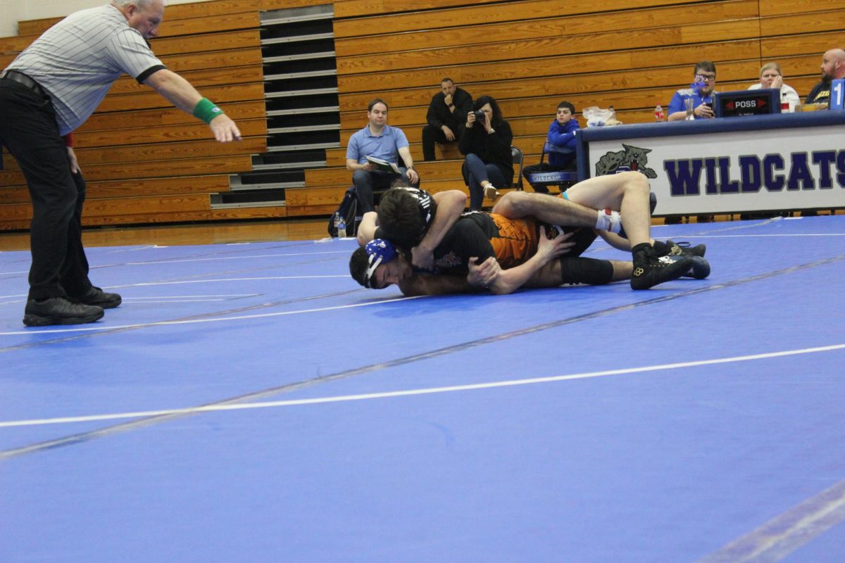 Caiden Covasos attempts to escape from underneath a wrestler from Bath County