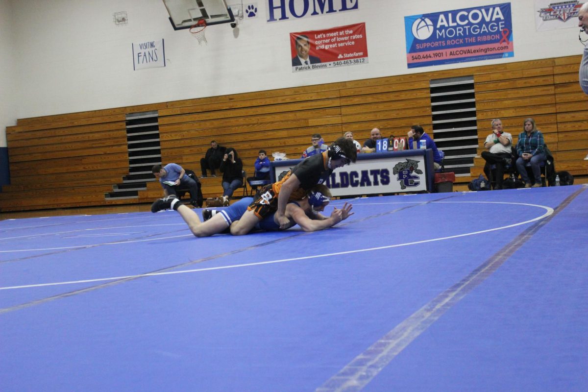 Markus Nelson attempts to escape from under a wrestler from Bath County