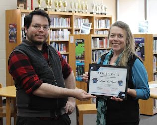 Rodriguez rewards Librarian Amanda Burks with the “Mental Health Champion” award.