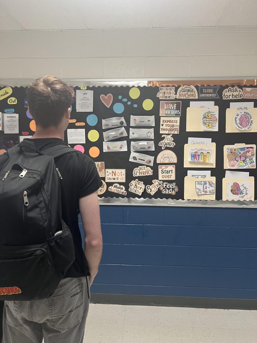 A student gazes at Mr. Rodriguez’s mental health board across from the library for motivation.