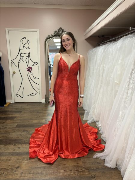 Senior Emma Woody poses in her red prom dress.
Photo courtesy Emma Woody