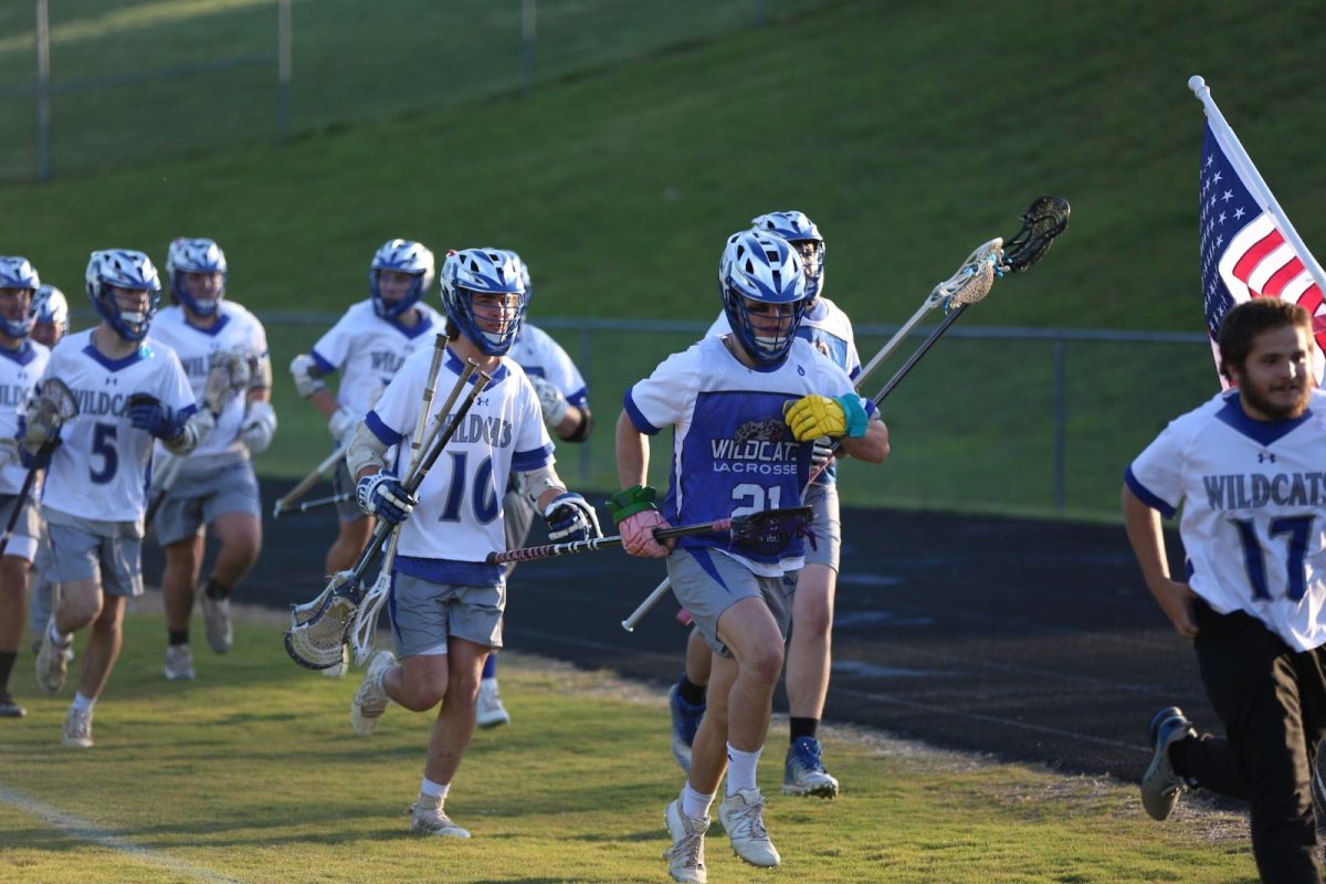 Senior number 21 Sawyer Hattersley runs out with the team to play against the Patrick Henry Patriots. 
