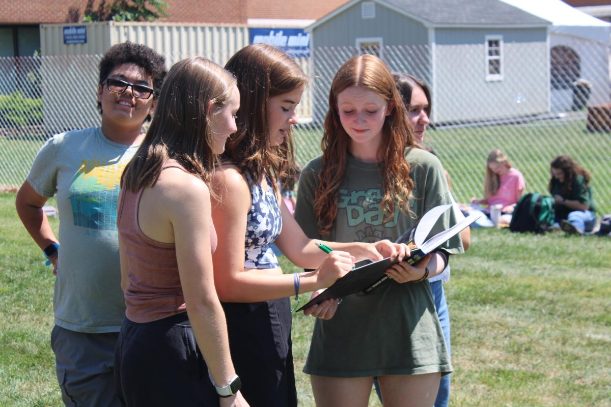 Student signs yearbook.