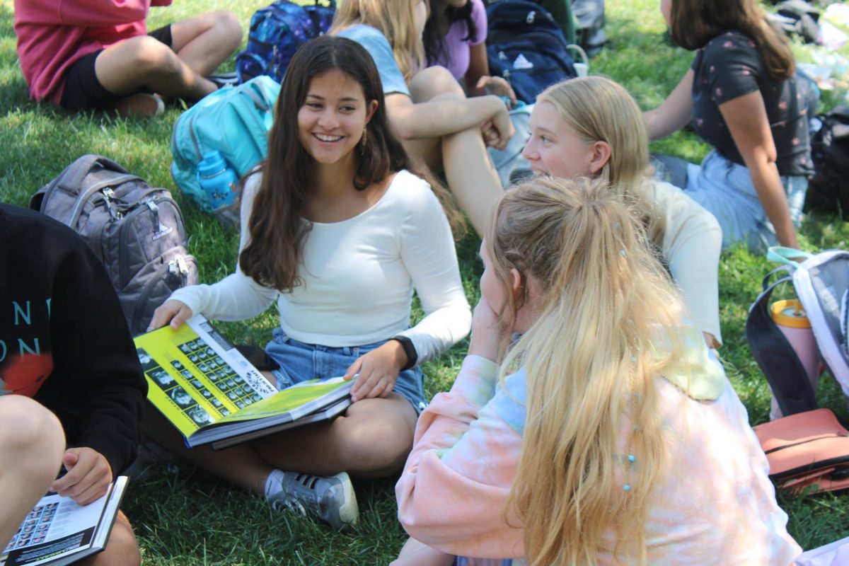 Sophomore Kadence Salins looks through the previous year’s yearbook.
