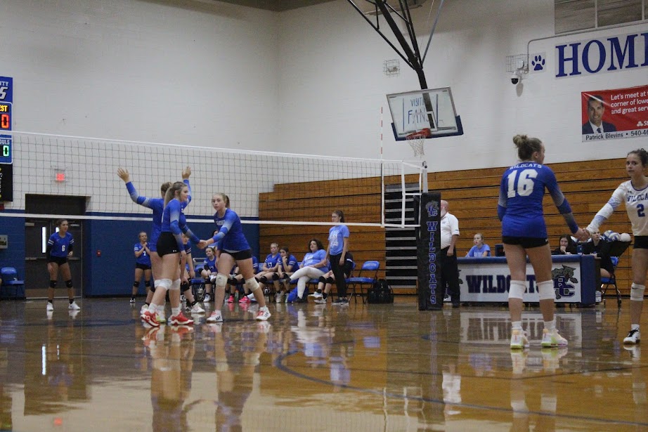 Sophomore Emma Johnson and freshman  Aubrey Wenger waits for their team to serve.