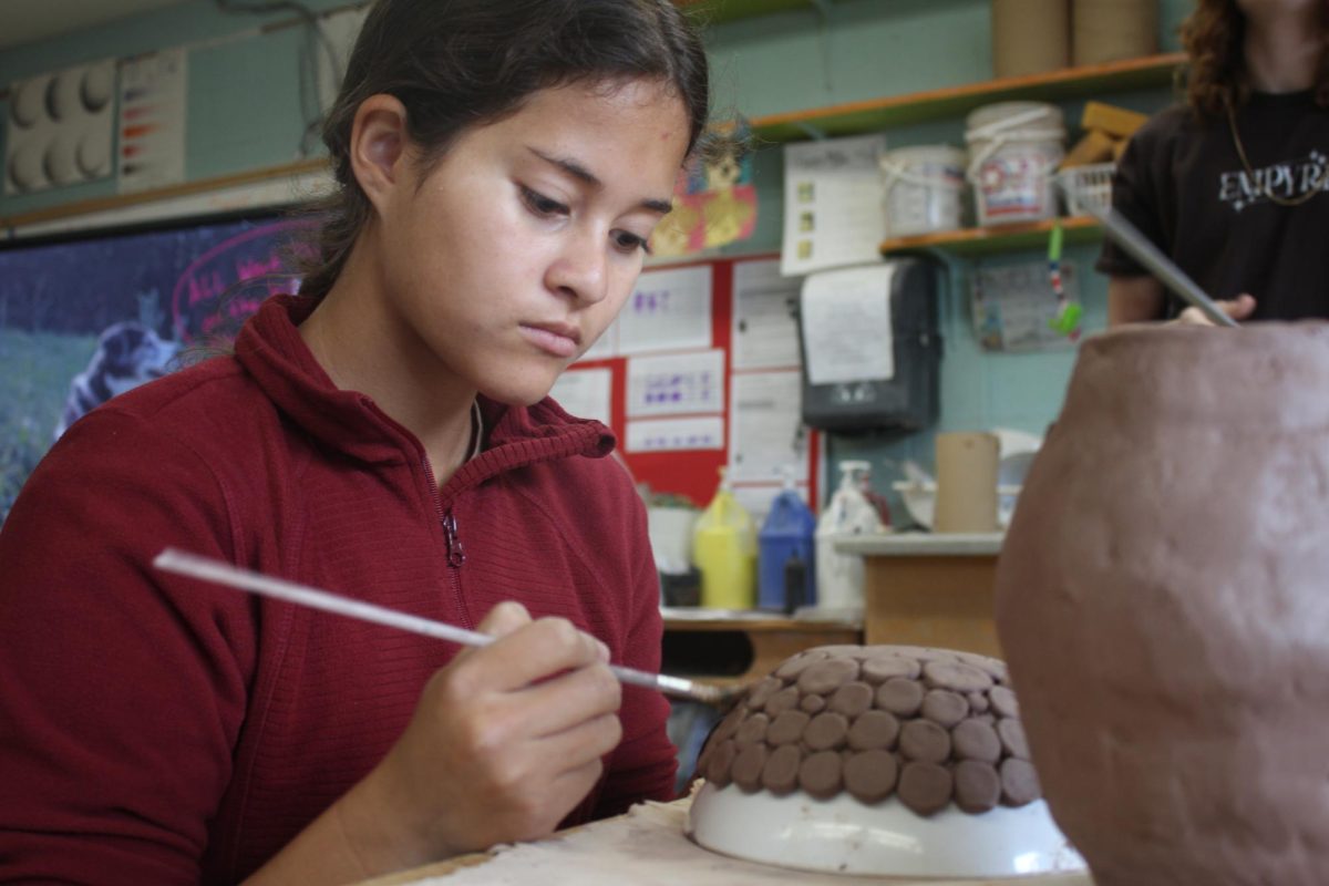 Sophmore Kadence Salins smooths out her bowl. 