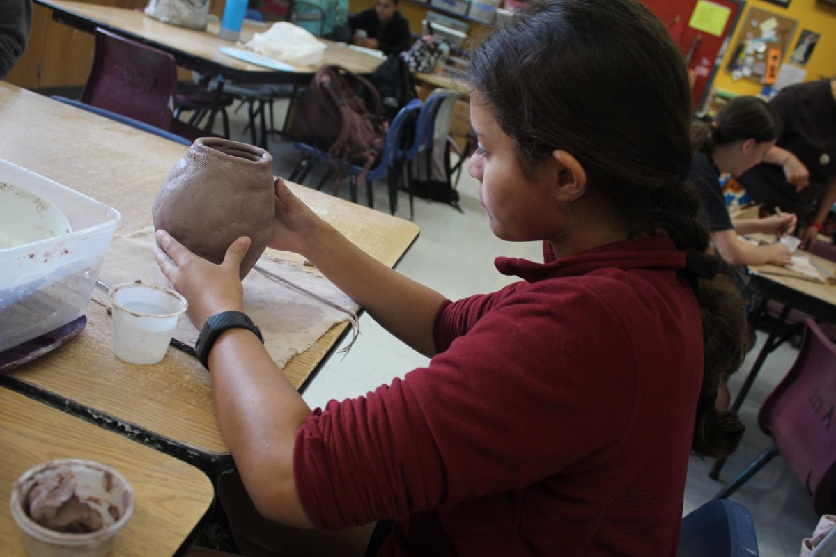 Sophmore Kadence Salins works on her vase.