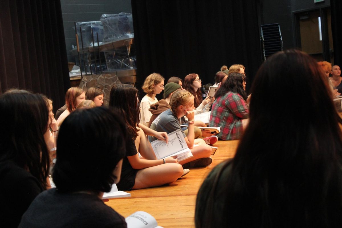 Students open up their scripts to begin rehearsal.