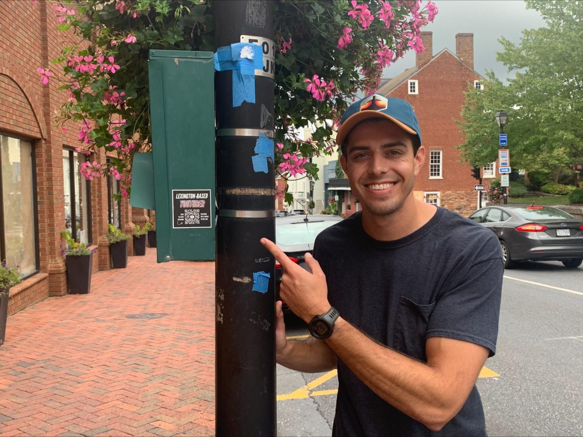 Sam Reid points to the promotional stickers he made.