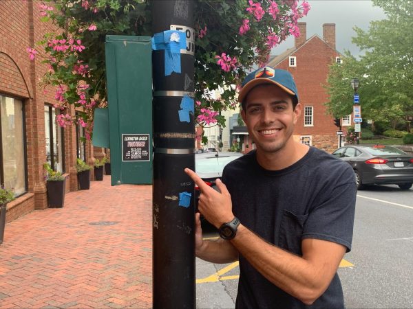 Sam Reid points to the promotional stickers he made.