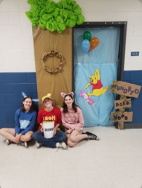 Lydia Kendall, Ella Culp, and Josie Kuehner pose in front of their trick-or-treat door at last year’s Halloween Fair.