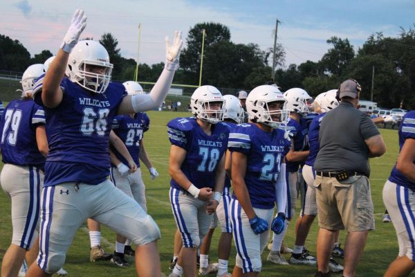 Junior Benjamin Davis celebrates an exciting play from the sidelines.