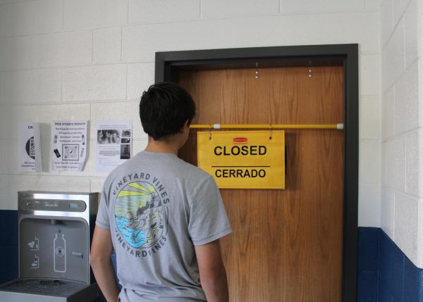 Junior Dean Fafatas encounters an obstacle while trying to use the restroom. Photo by Addie Flint.