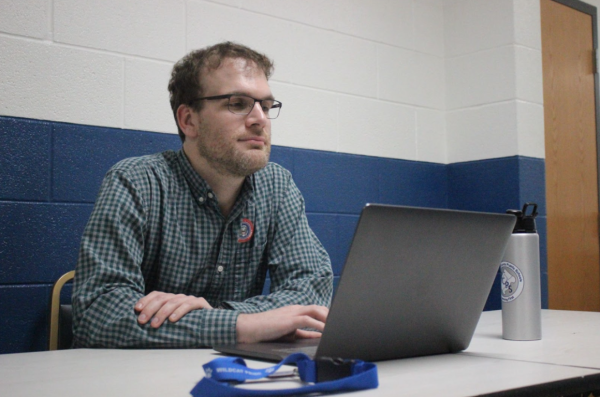 Chris Gallagher checks a student into the bathroom.