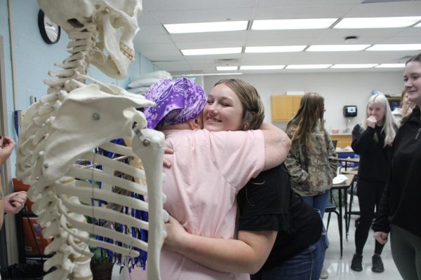 Junior Lily Ballard hugging Pat Connor