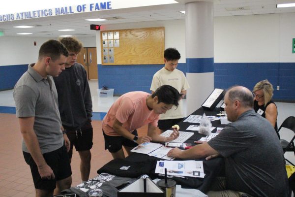 Senior Ayron Wu purchases his cap and gown for graduation. Photo curtesy of Cameron Terry.