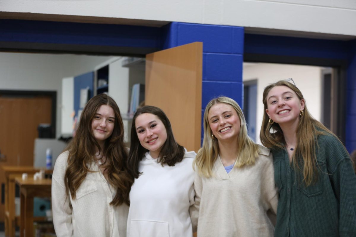 President Nadia Gaydos, vice president Schulyer Coleman, and members Savannah Whitmer and Emma Johnson pose for a group photo.