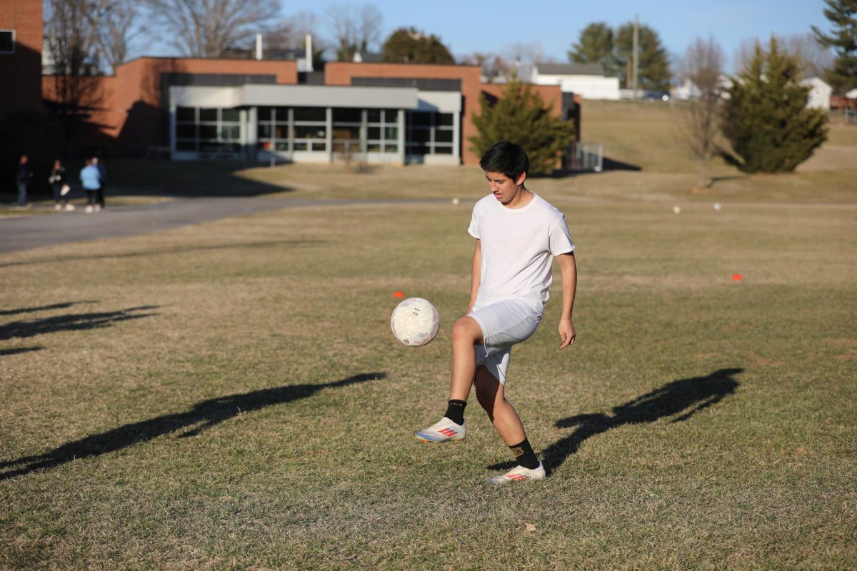 Junior Juan Rodriguez kicks the ball