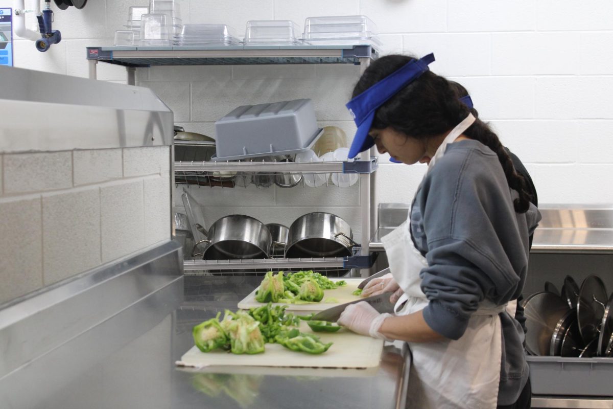 Juniors Briana Itehua-Lopez and Karla Macedo prepare peppers in the new kitchen.