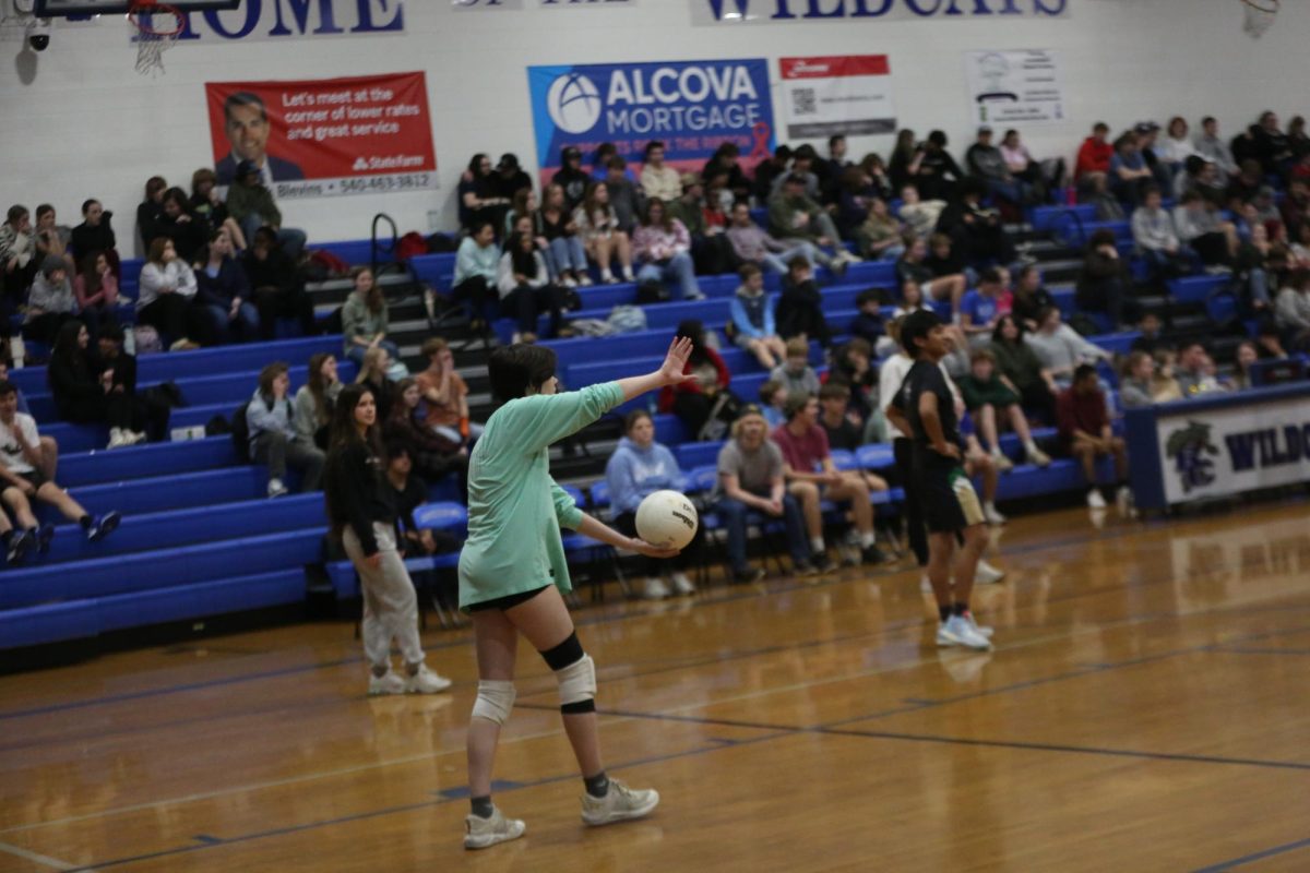 Junior student serves the ball.