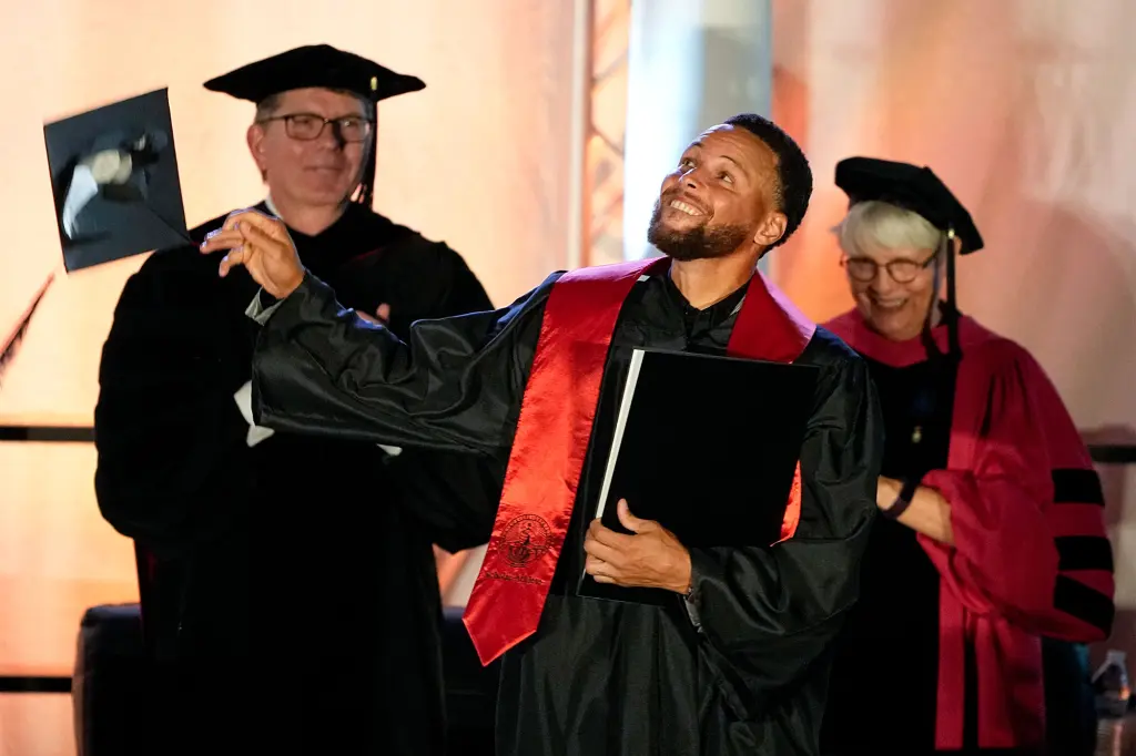 Stephen Curry accepts his degree from Davidson after graduating in 2022.
Photo by Chris Carlson/AP