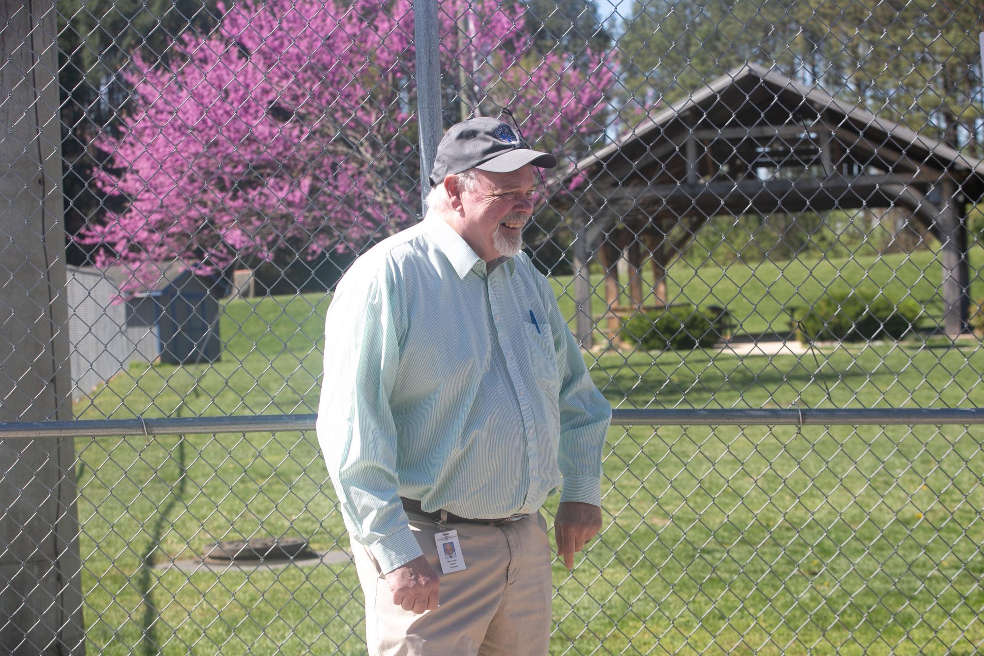 Prinincipal Dr Micheal Craft looks at students walking to the stadium in their cap and gowns.